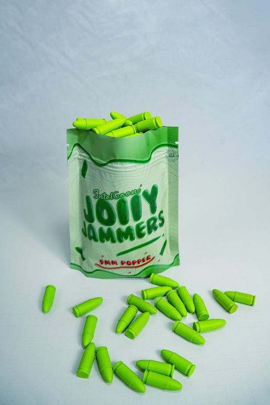 A pack of Jolly Jammers, green 9MM malfunction rounds, displayed with several rounds scattered in front.