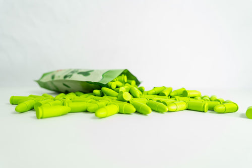 A pack of Jolly Jammers, green 9MM malfunction rounds, displayed with several rounds scattered in front.