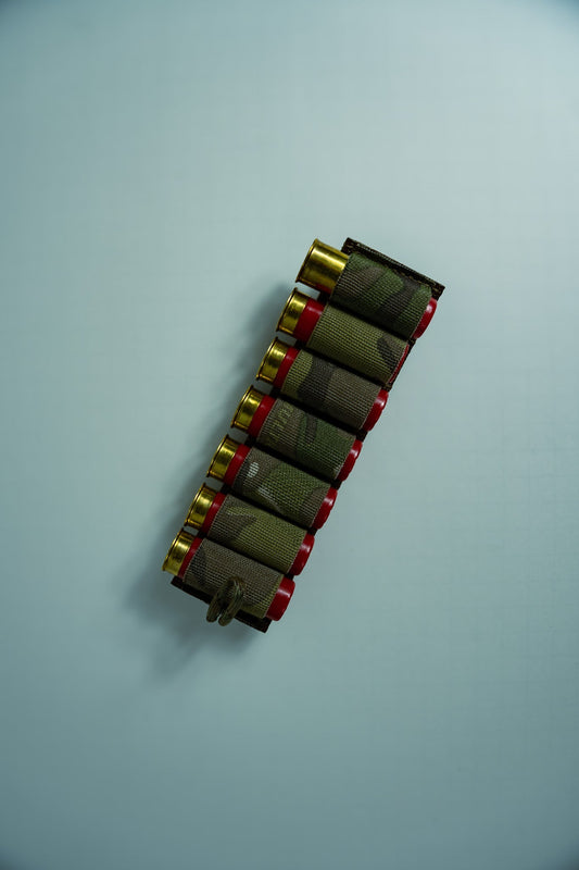 Image of the Esstac 7 Round 12 Gauge Shotgun Card, showcasing a durable, low-profile design with elastic loops for securely holding 7 shotgun shells. Ideal for rapid reloads and easy mounting on tactical gear.