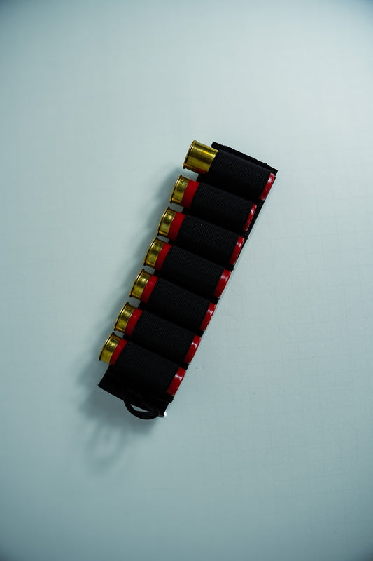 Image of the Esstac 7 Round 12 Gauge Shotgun Card, showcasing a durable, low-profile design with elastic loops for securely holding 7 shotgun shells. Ideal for rapid reloads and easy mounting on tactical gear.