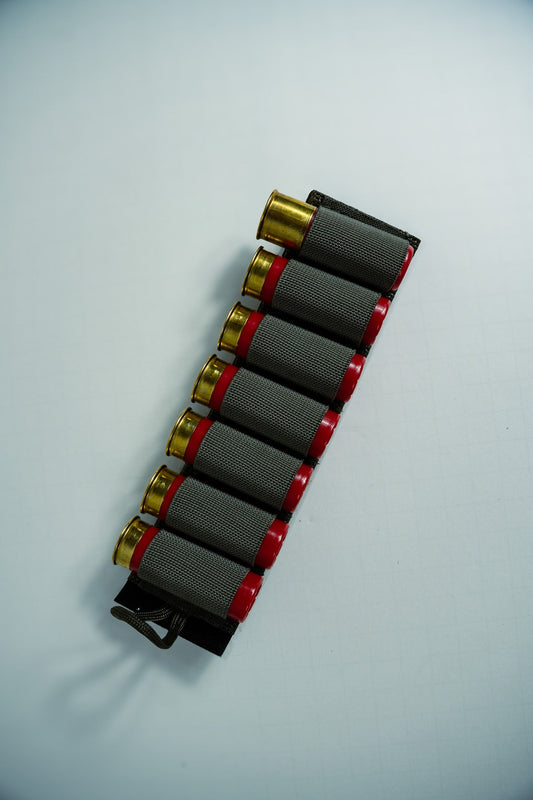Image of the Esstac 7 Round 12 Gauge Shotgun Card, showcasing a durable, low-profile design with elastic loops for securely holding 7 shotgun shells. Ideal for rapid reloads and easy mounting on tactical gear.