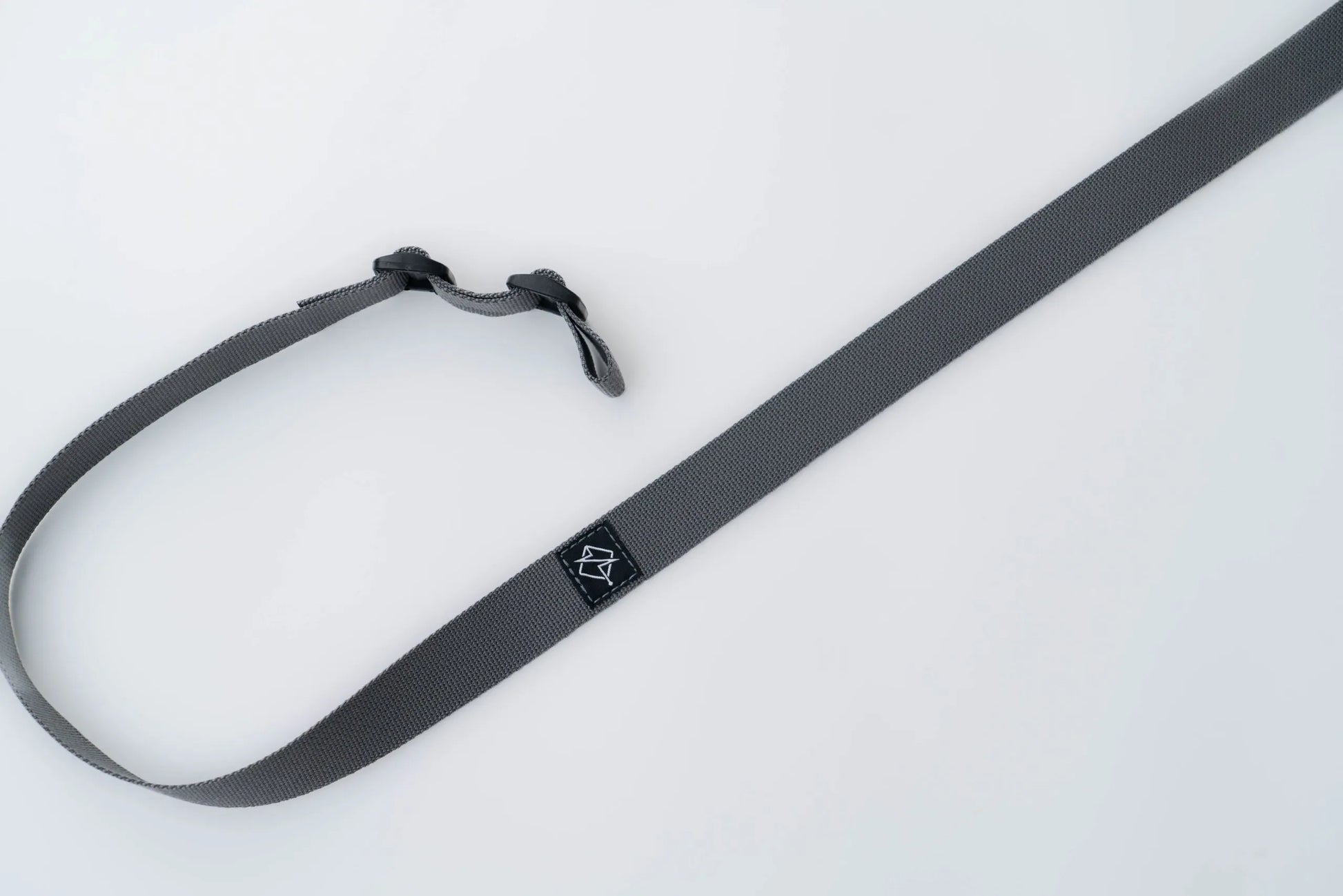 Close-up of quick-adjust pull tab and ladder lock on rifle sling