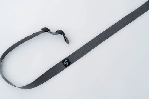 Close-up of quick-adjust pull tab and ladder lock on rifle sling